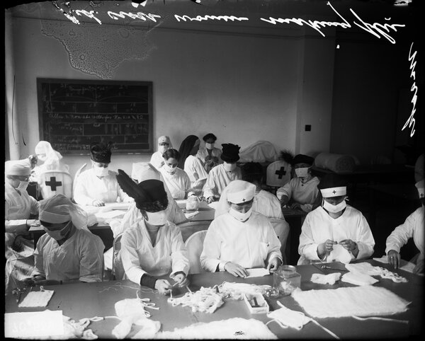 Red Cross workers in Chicago constructing face masks during the influenza pandemic in 1918.