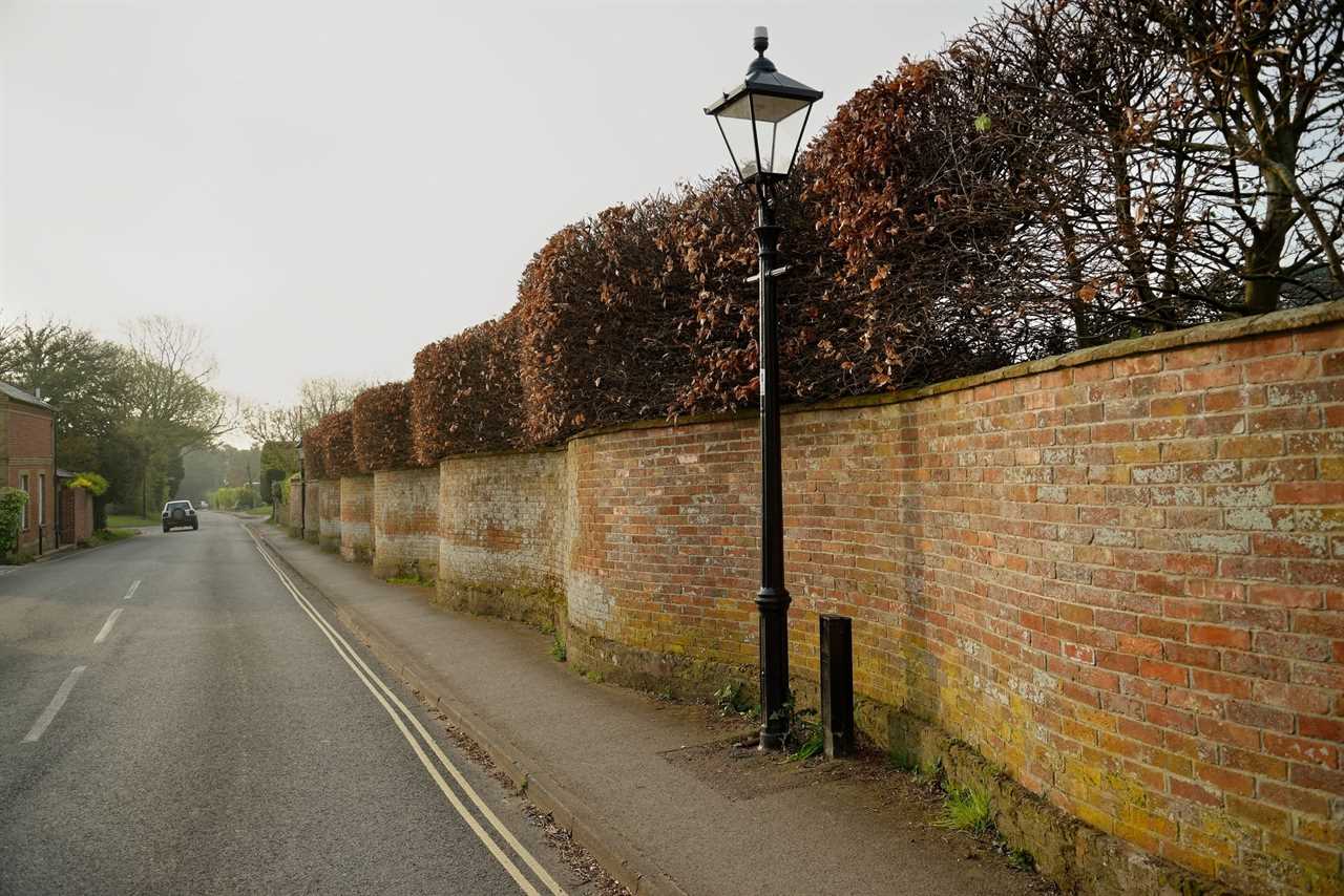 Curvy wavy wall made from red bricks along a roadway in the united kingdom