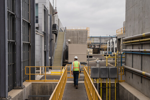 An official with the San Diego County Water Authority walked through the desalination plant in Carlsbad.