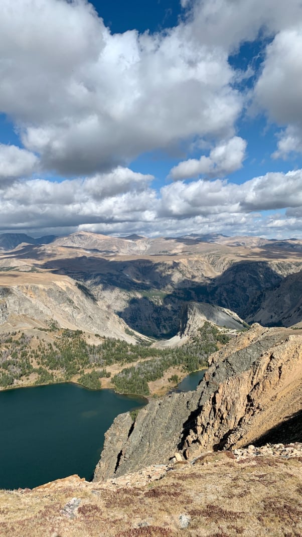 View of a high elevation lake and mountain landscape along the Beartooth Highway.