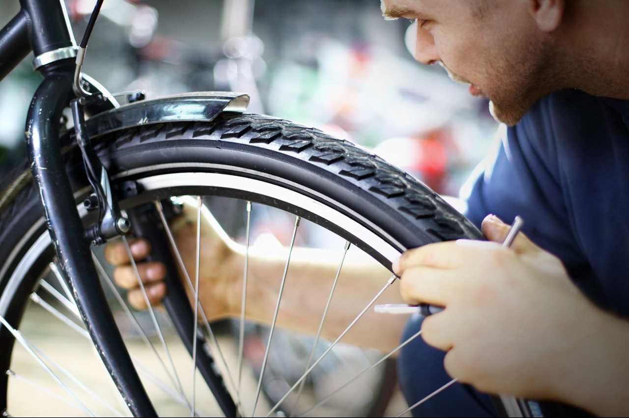 Bike mechanic repairing a wheel