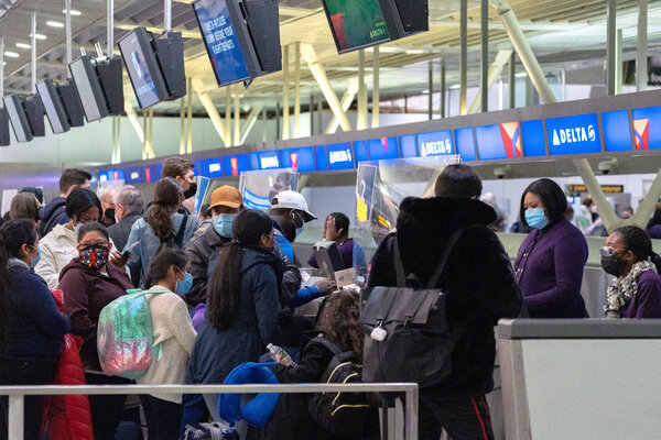 Checking in at Kennedy Airport in New York on Sunday. In 2021, there were 5,779 reports of unruly passengers on planes, most of them related to mask mandates, the Federal Aviation Administration says.