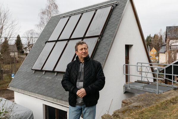 Henry Backhaus at his house in Colmnitz in Saxony, Germany. He’s able to burn wood and coal to reduce his energy bill and the solar panels work with a boiler that heats his water.