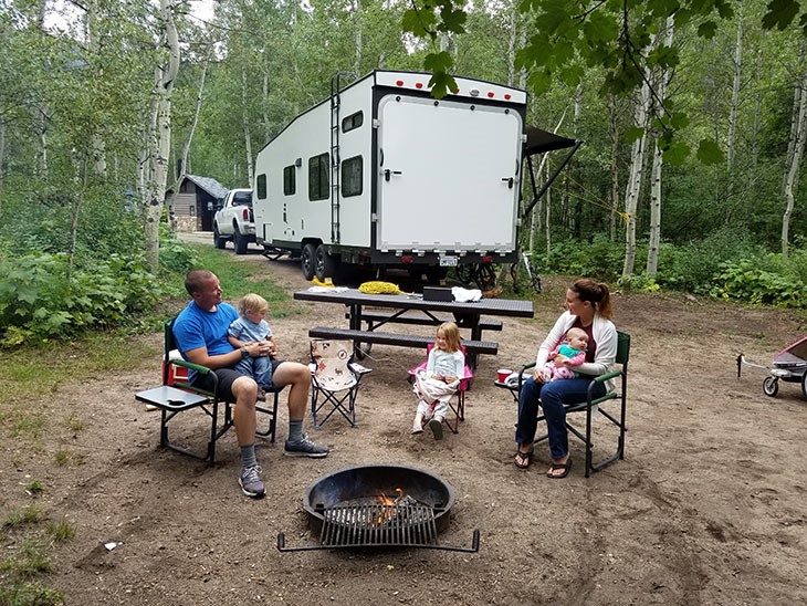 Family having fun outdoor after a road trip