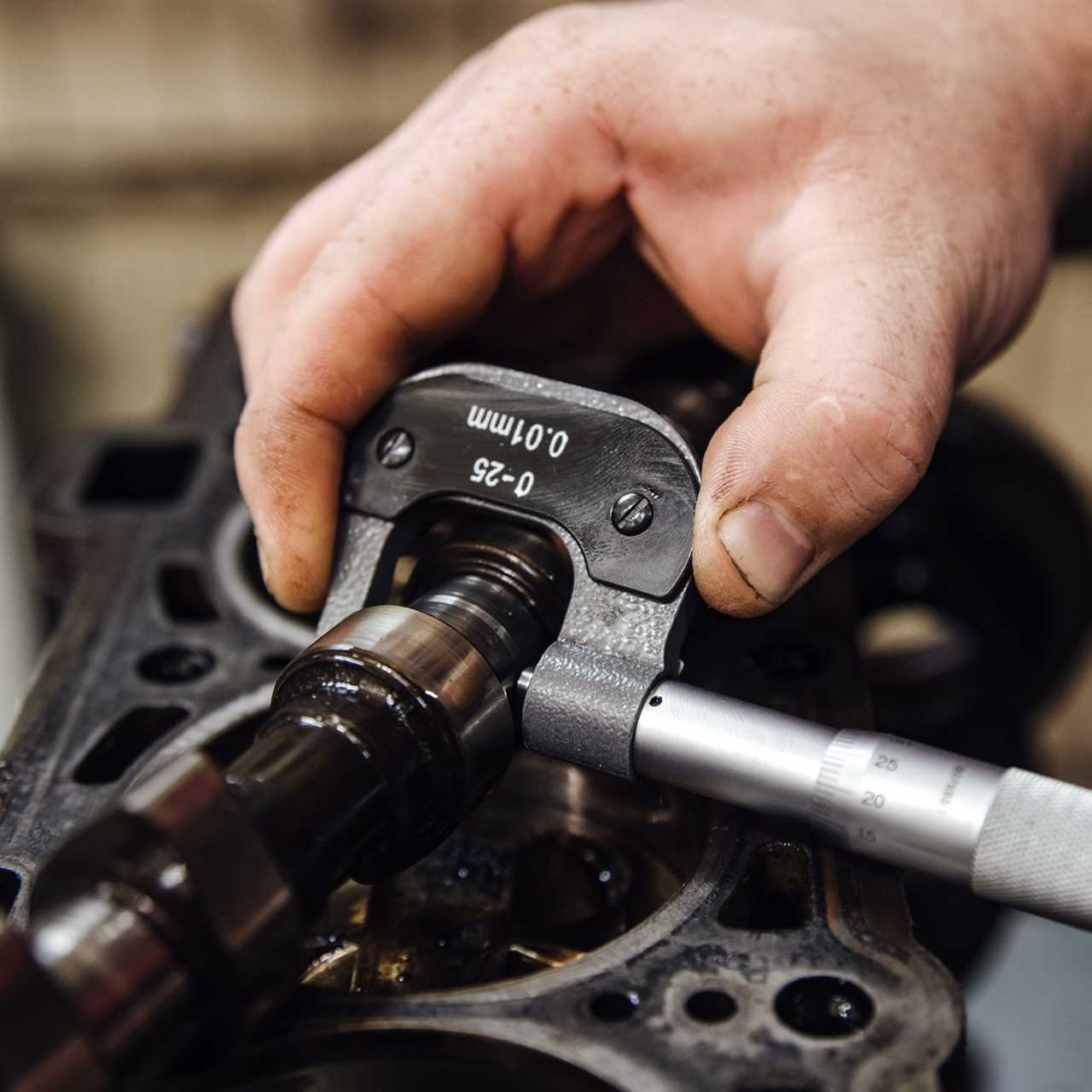 measuring instrument in hands against the background of the engine at a shallow depth of field