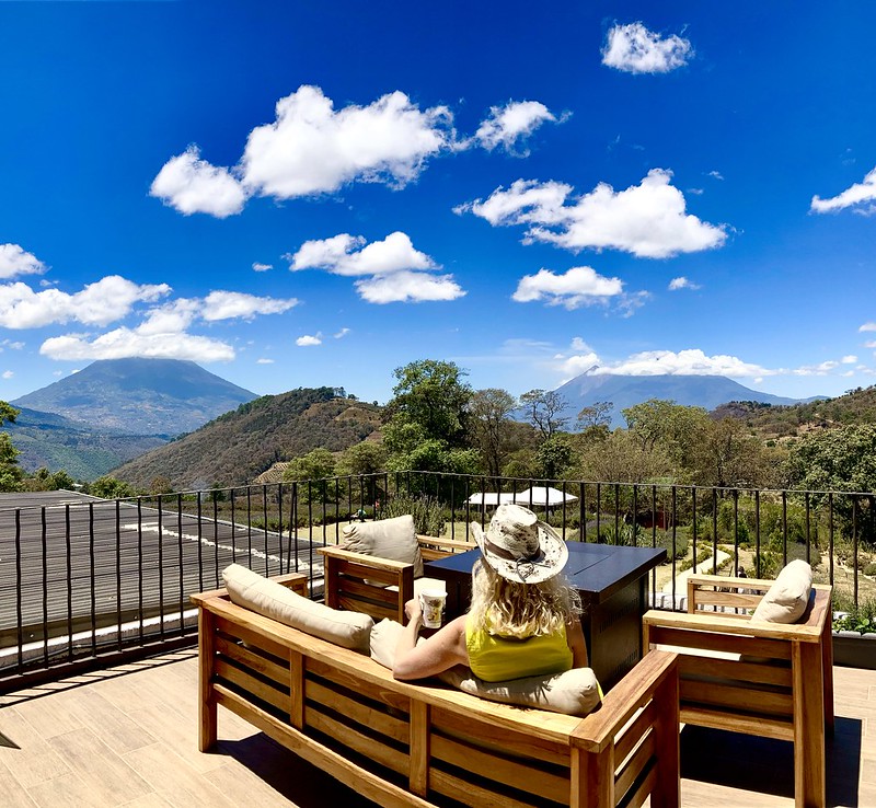 woman sitting while looking to an amazing view in antigua, guatemala