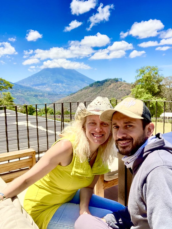 woman and a guy taking a selfie with a volcano on the background in antigua, guatemala