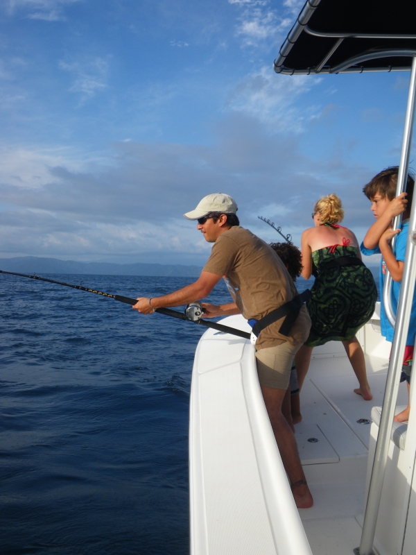 people on a boat doing deep sea fishing