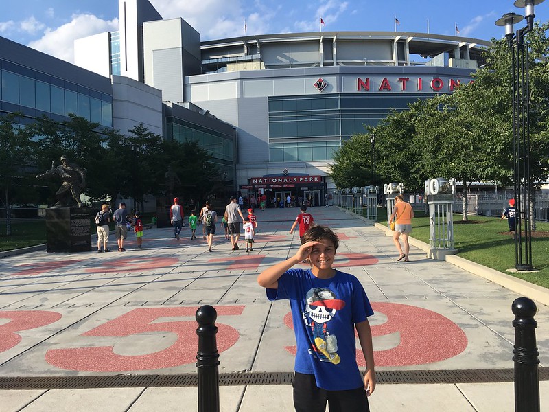 kid with some people at the background at the nationals park in washington dc