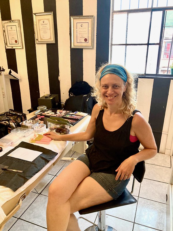 woman and a table with make up gear in a make up workshop