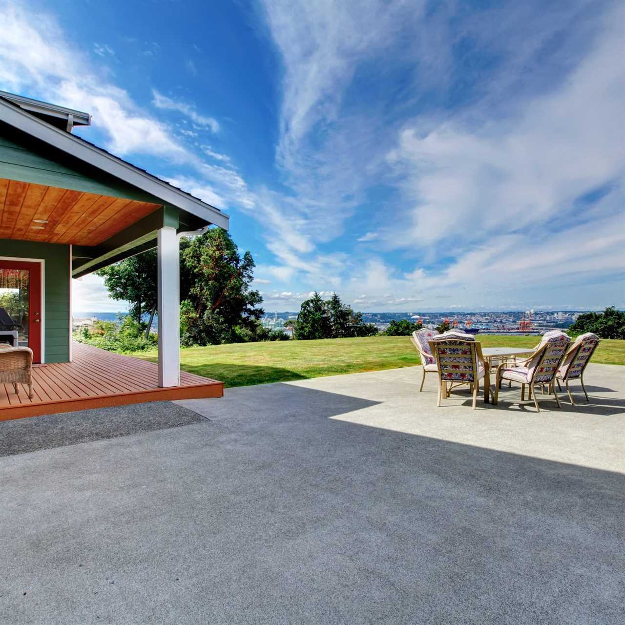 VIew of large concrete floor patio area at backyard