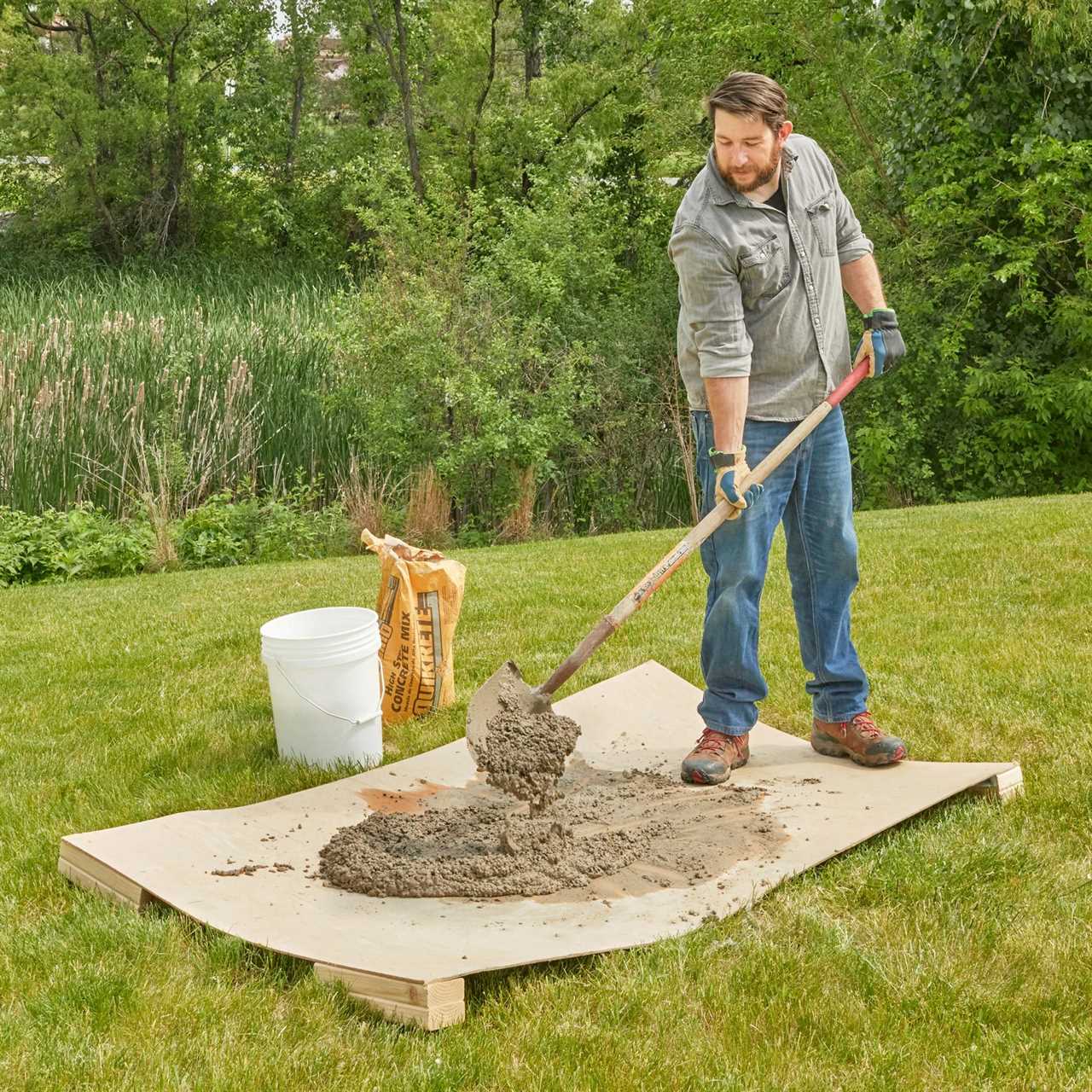 mixing concrete on a piece of plywood