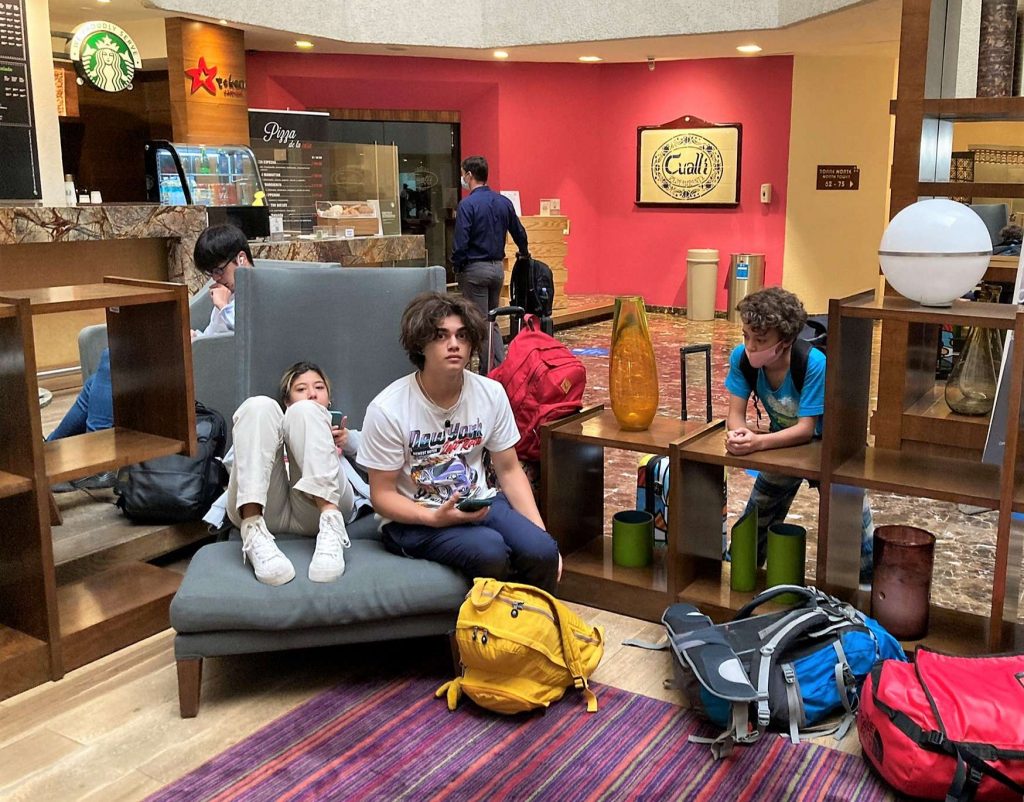 teens sitting around at the mexico city airport