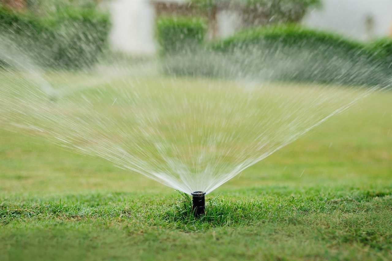 Automatic garden lawn sprinkler in action watering grass