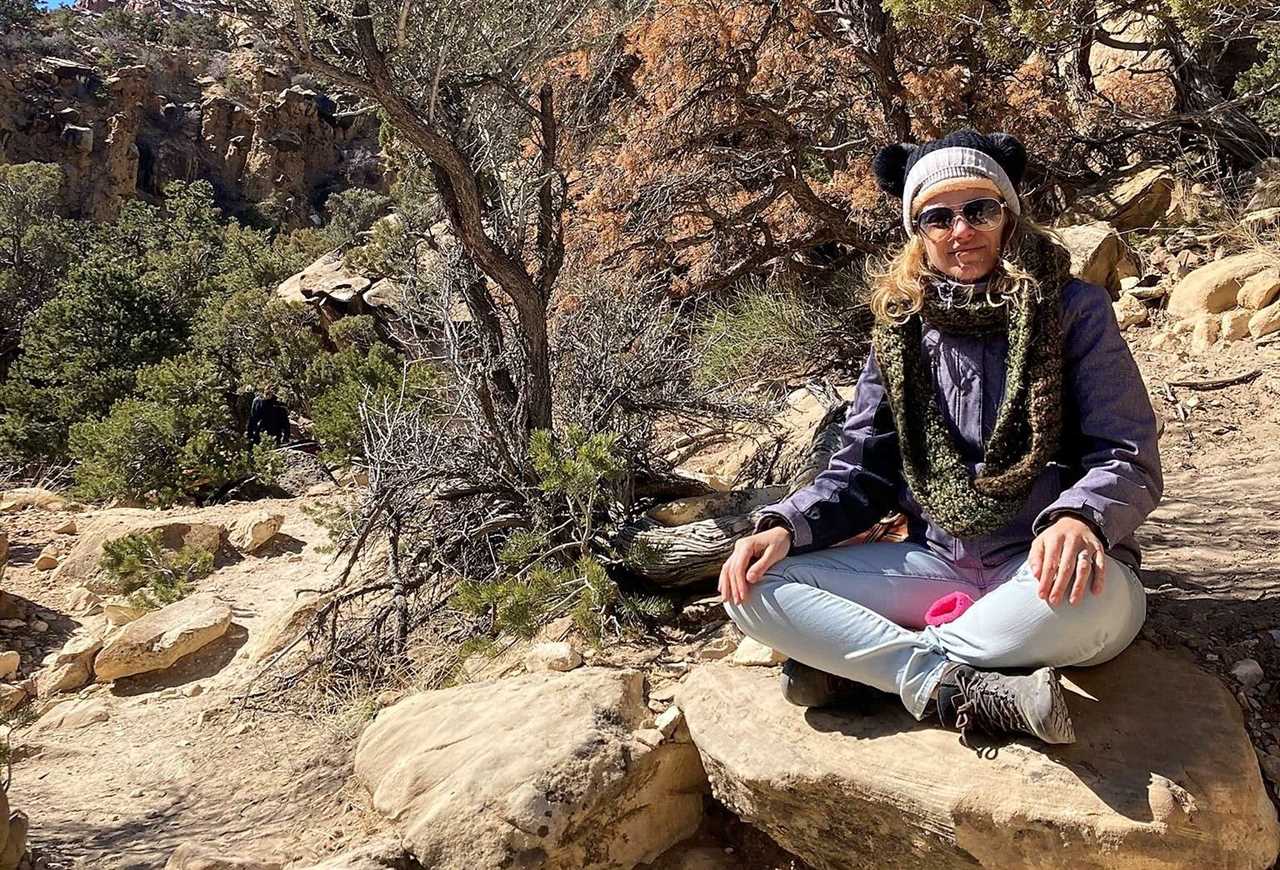 Woman sitting on a rock in joe valley utah