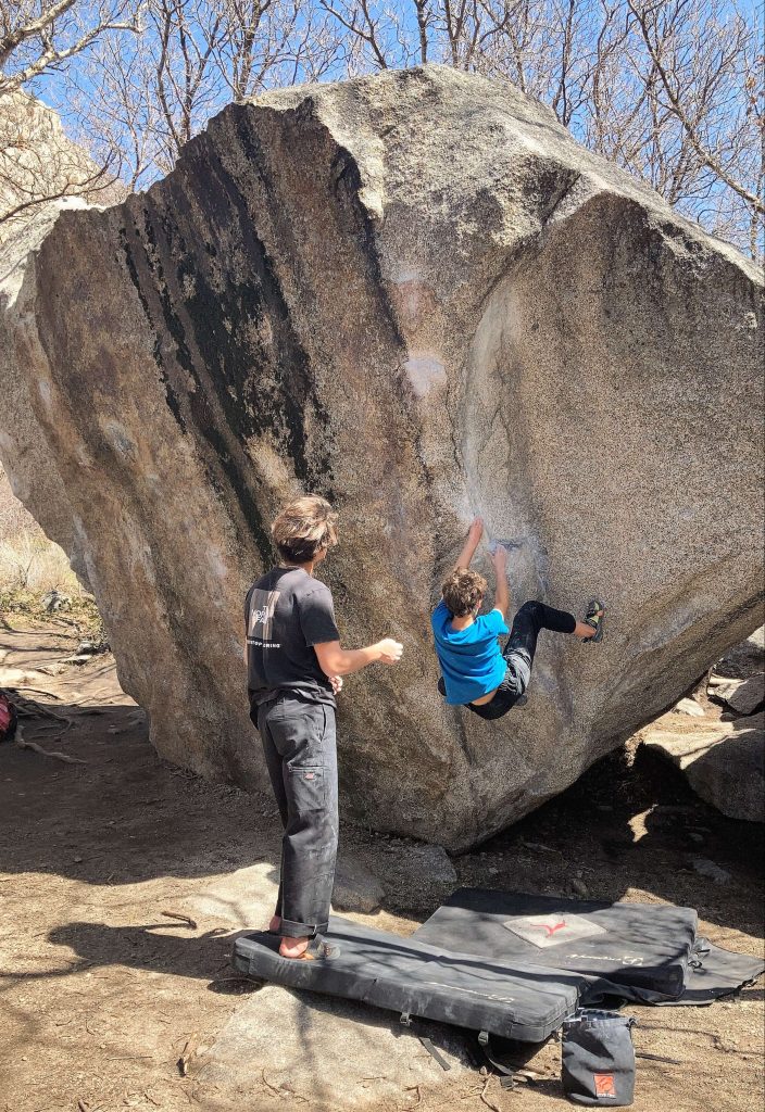 two kids doing bouldering at little cottonwood canyon