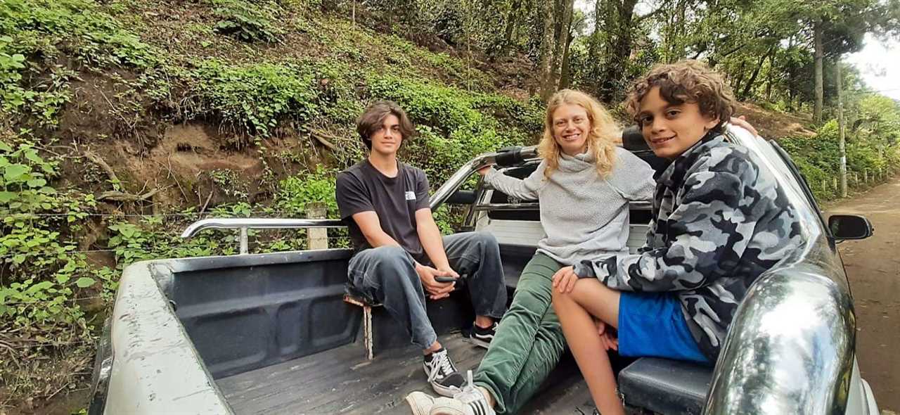 mom and two kids on the back of a truck