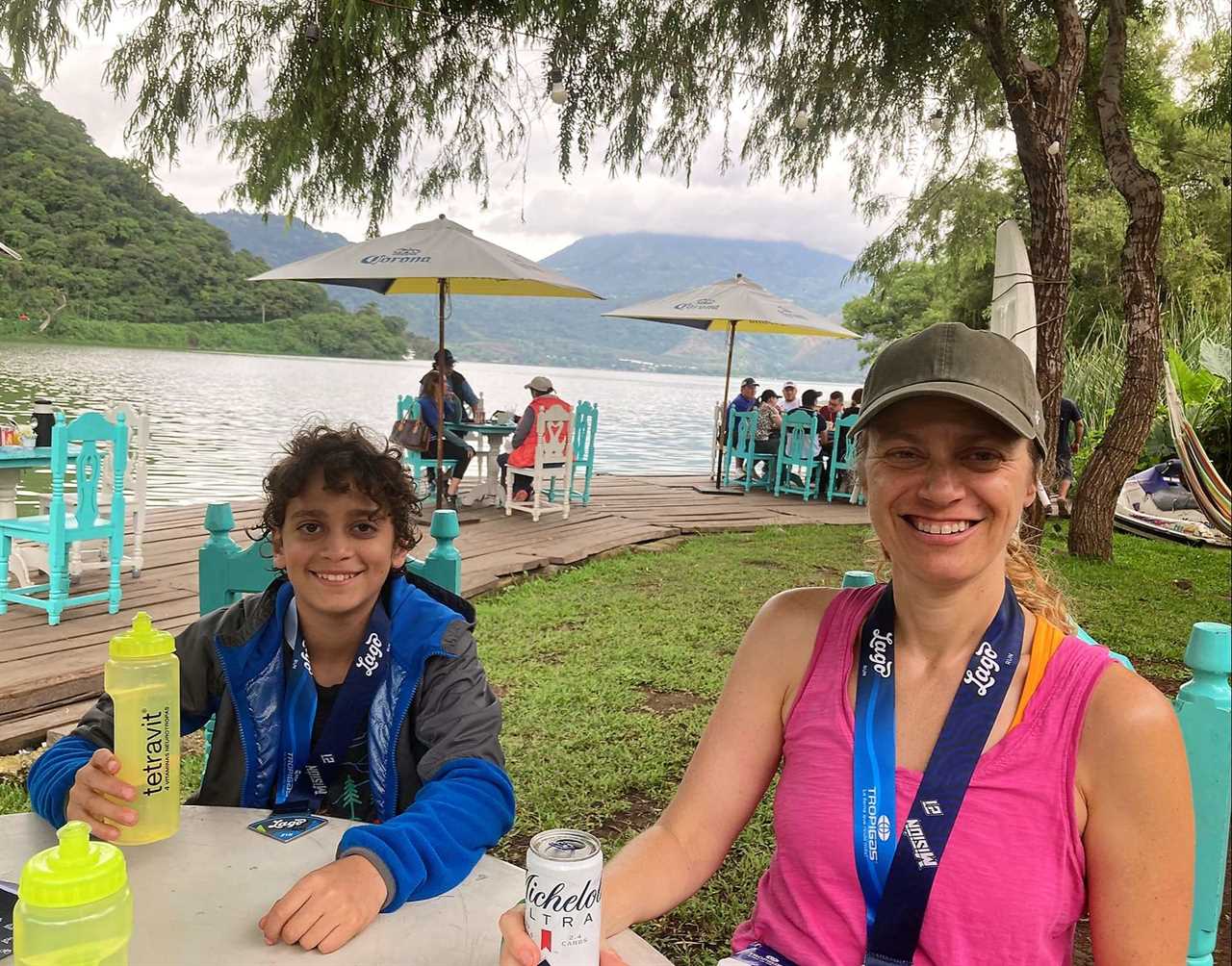 woman and a kid having breakfast near a lake in guatemala