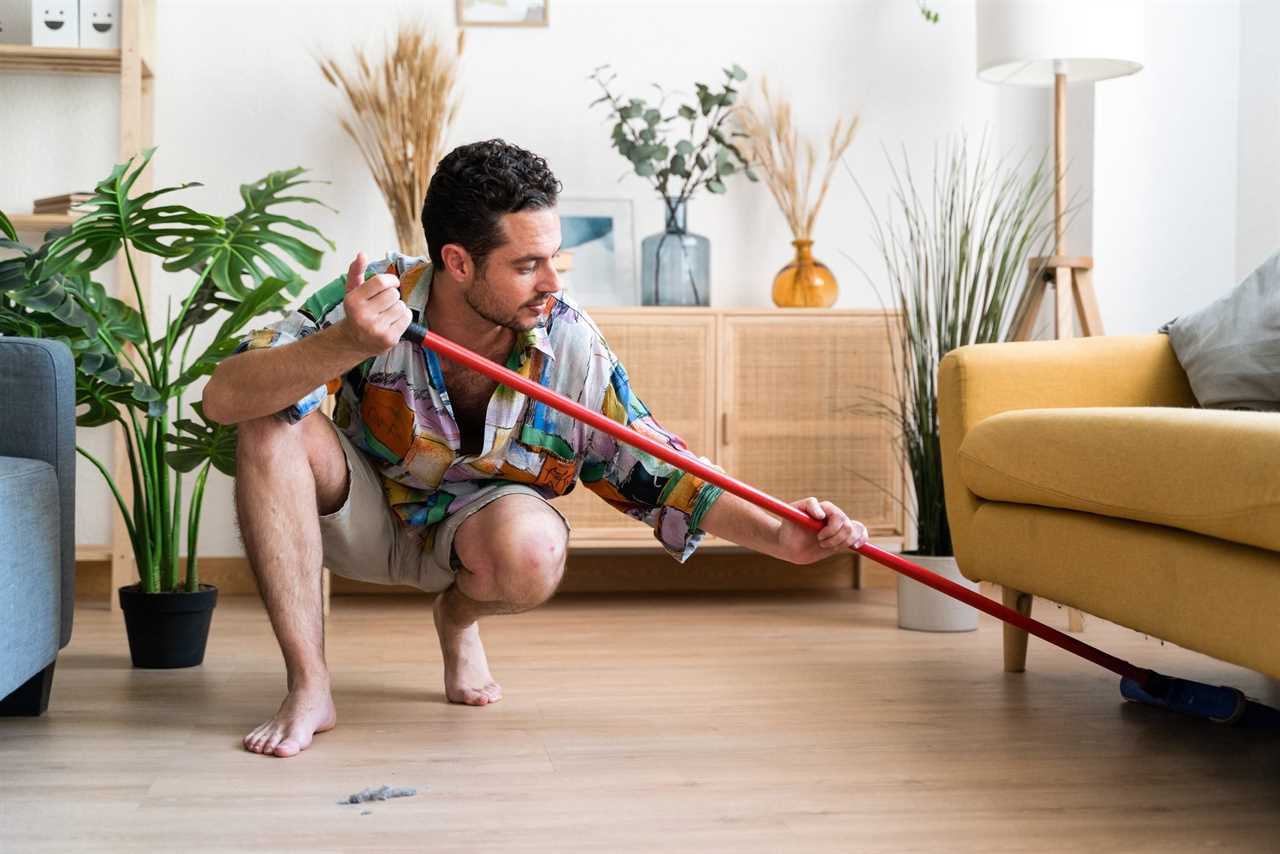 Man cleaning the floor with broom.