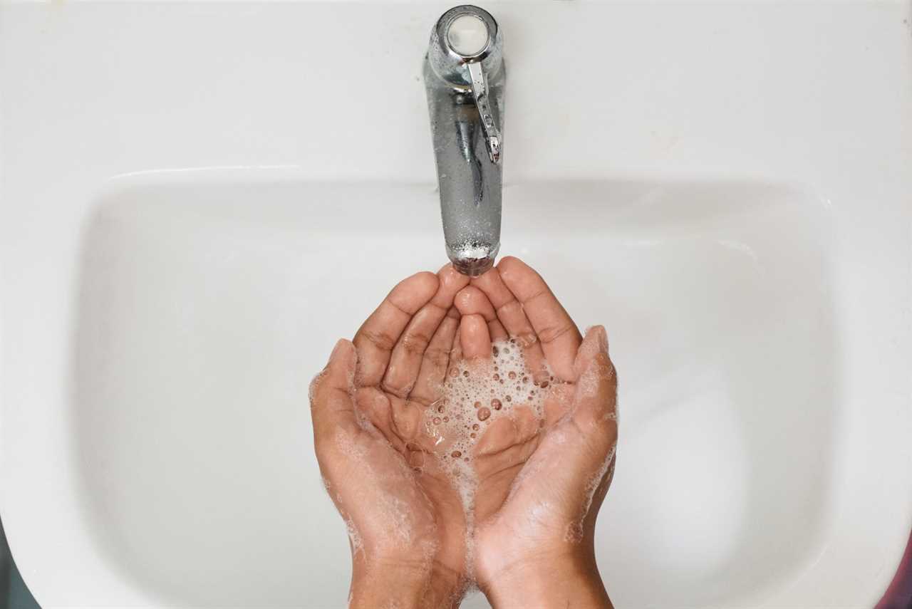 Cropped Image Of Person Washing Hands