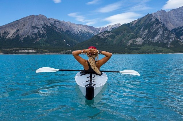 woman resting on a kayak