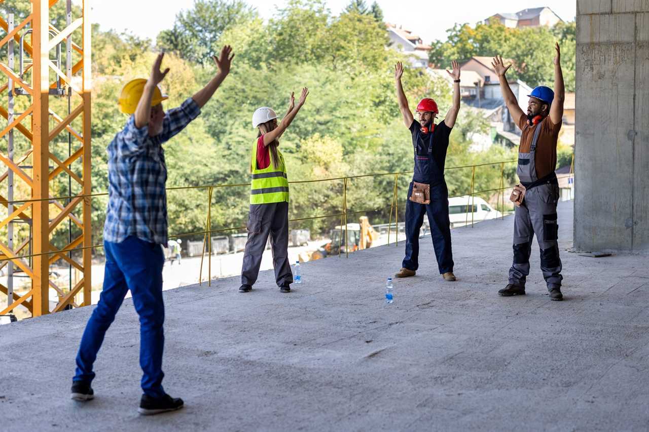 A Group of Multicultural Workers are Exercising During a Work and Stretching a Muscles.