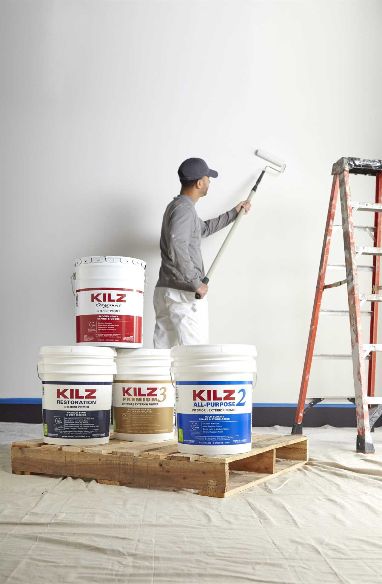 Man painting wall with KILZ