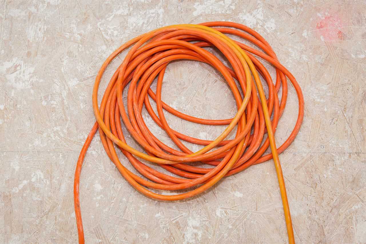 orange Extension Cord on a plywood floor