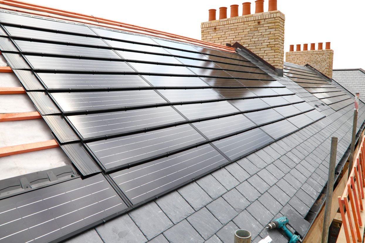 A new house getting solar panels fitted on its roof.