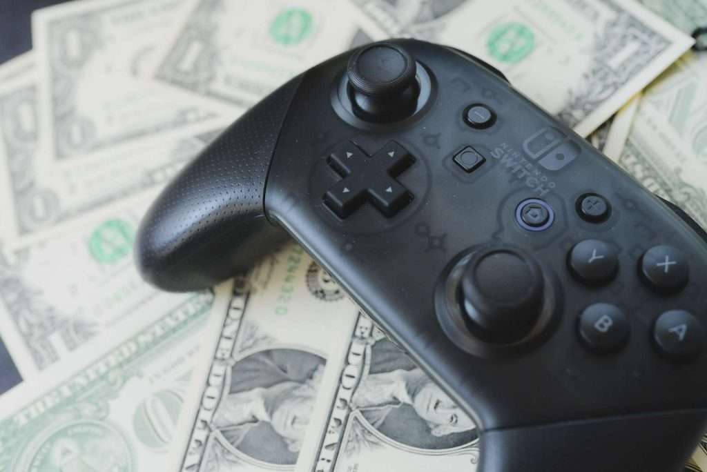 a video game controller on top of money