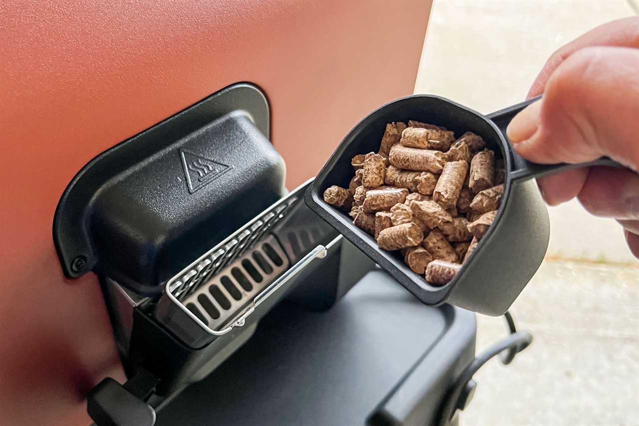 Pouring Smoke Wood Pellets into Ninja Woodfire Outdoor Oven