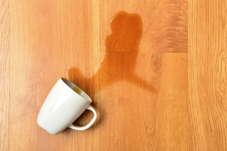 Coffee Spilled onto Hardwood Floors from glass, white coffee mug