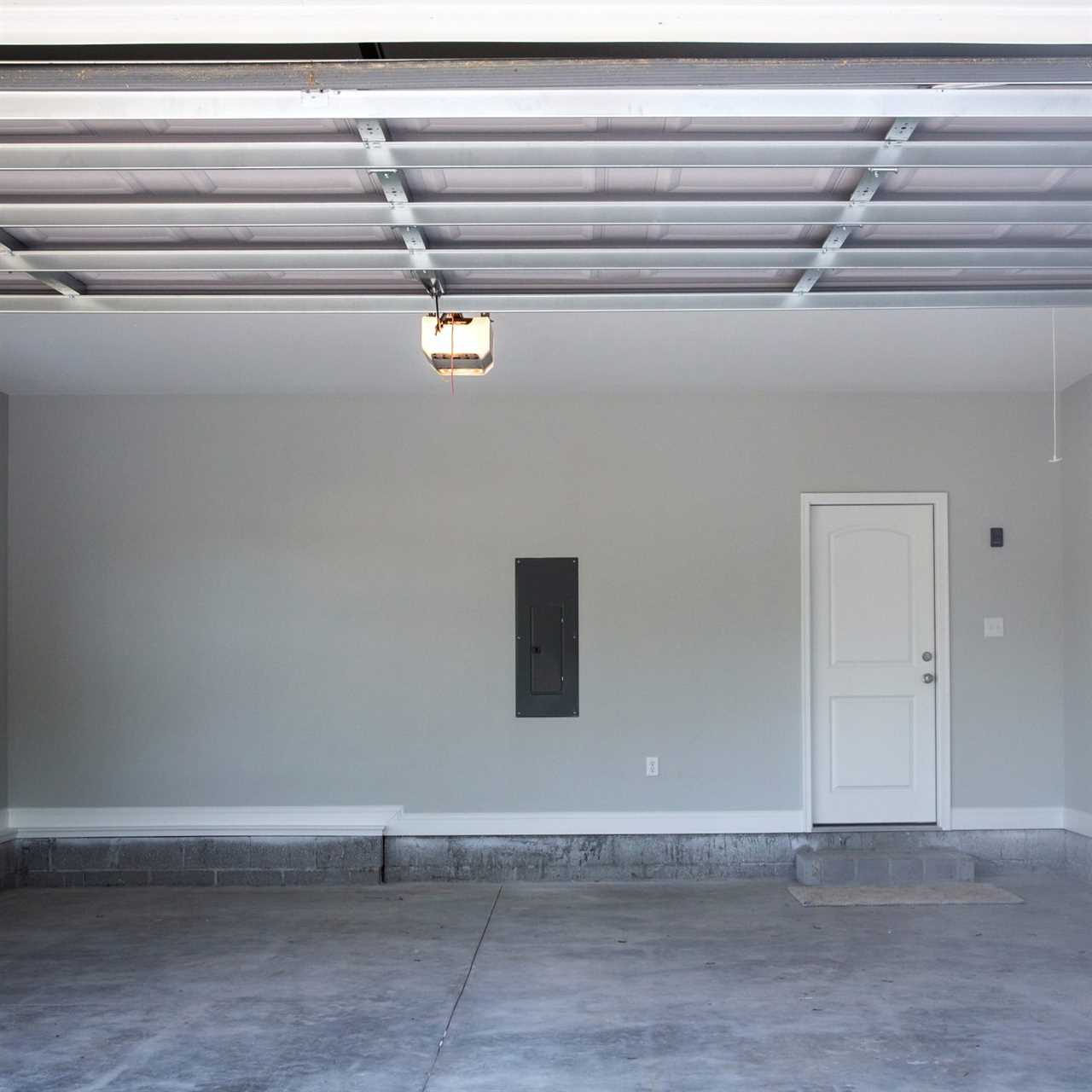 Empty large two-car garage with cement floor