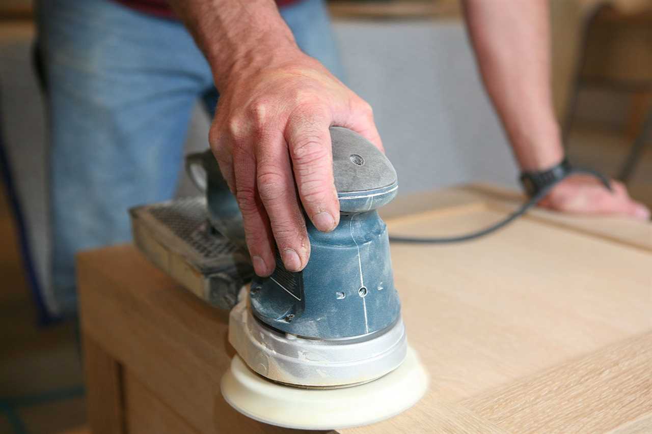 Carpenter Power Sanding White Oak cabinet in a residential setting