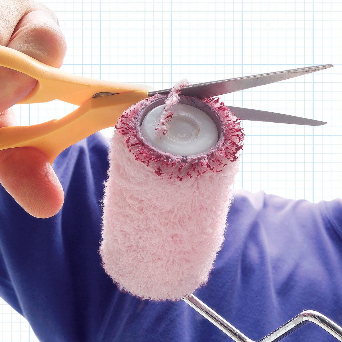 Cutting the Edges of a Paint Roller With Scissor