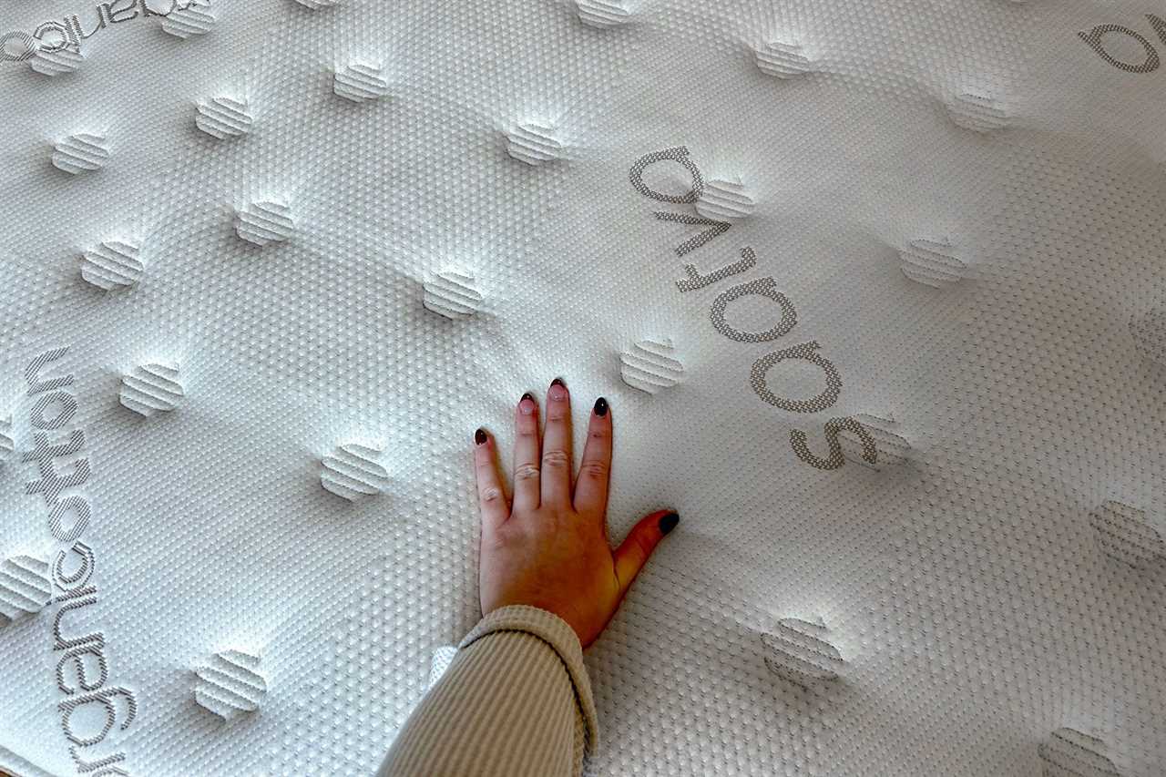 Woman's hand on mattress 