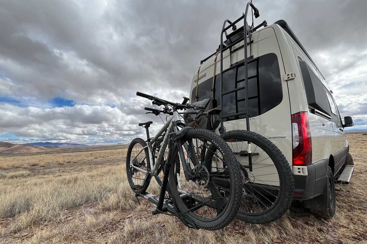 Bikes locked on rack behind van