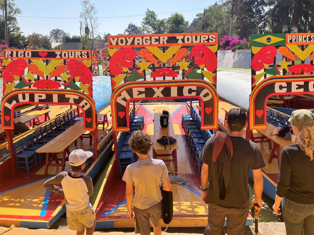 family watching the colorful boats in xochimilco