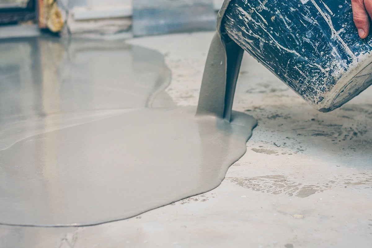 Worker finishes pouring over the bulk concrete floor