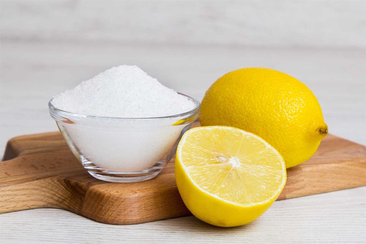 salt and lemons on a wooden cutting board